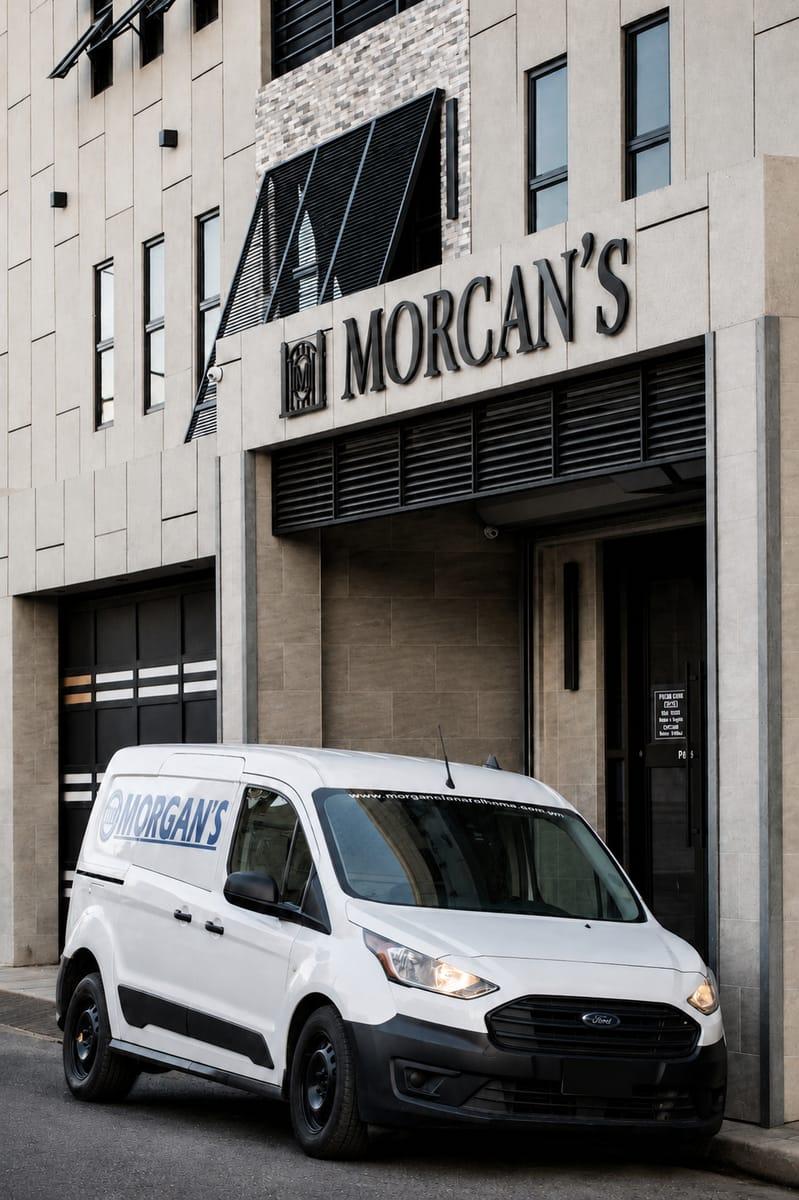 Morgan's Funeral Home building exterior with a Morgan's transport van parked at the entrance